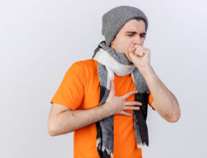 coughing-young-ill-man-wearing-winter-hat-with-scarf-putting-hand-mouth-isolated-white